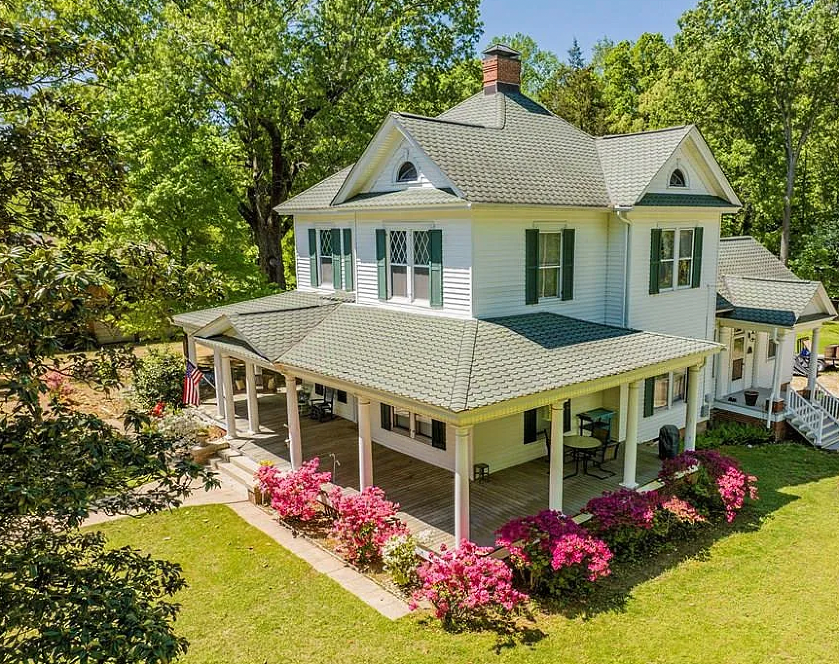The Viridia wraparound porch with blooming azaleas